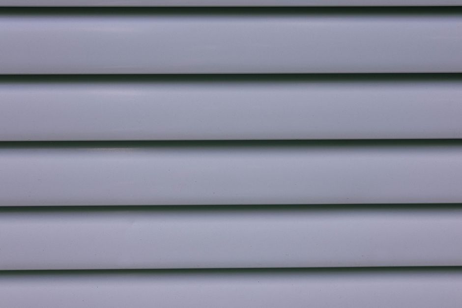 Installing fresh vinyl siding on a residential home